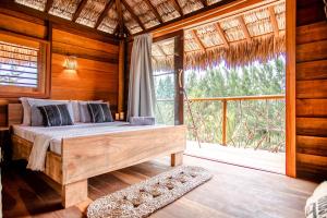 a bedroom with a bed and a large window at A Piscina Itaca in Barrinha