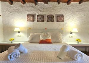a bedroom with a large bed with towels on it at Villa Ses Casetes Ibiza in Montecristo +29 photos