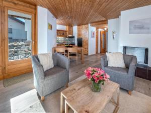a living room with two chairs and a coffee table at Apartment Schweizerhof 234 by Interhome in Lenzerheide +19 photos