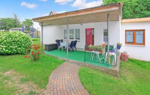 a house with a green deck with a table and chairs at Ferienhaus Blankensee in Blankensee