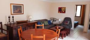a living room with a table and a couch at Vautrain in Artignosc-sur-Verdon