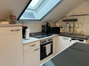 a kitchen with a stove and a skylight at Apartment Garden by Interhome in Karl