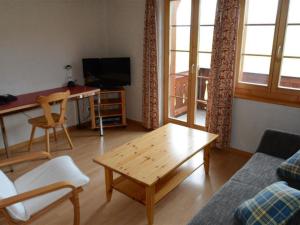 a living room with a couch and a coffee table at Apartment Henry - 1- Stock by Interhome in Schönried +7 photos