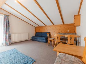 a living room with a blue couch and a table at Apartment Wildkogel 1 by Interhome in Neukirchen am Großvenediger