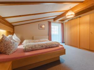 a bedroom with a large bed in a room at Apartment Wildkogel 1 by Interhome in Neukirchen am Großvenediger +30 photos
