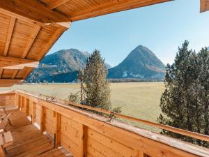 a porch with a view of a field and mountains at Apartment Wildkogel 1 by Interhome in Neukirchen am Großvenediger