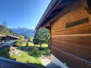a wooden building with a sign on the side of it at Apartment Wildbach by Interhome in Lenk