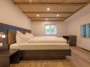 a bedroom with a large bed and a window at Apartment Haus Bergsonne by Interhome in Saas-Almagell