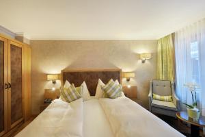 Rúm í herbergi á Hotel Kirchbühl Superior