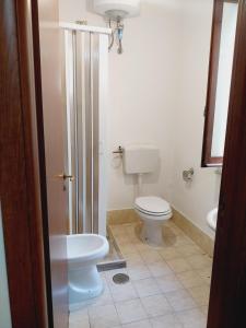 a bathroom with a toilet and a sink at Marina di Montauro - Lido di Pietragrande in Montepaone Lido +17 photos