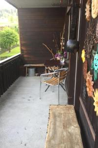 a patio with a table and a chair in a building at Apartment Morion by Interhome in Lenk