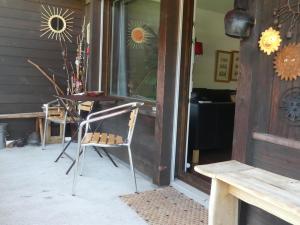 two chairs and a table in front of a building at Apartment Morion by Interhome in Lenk