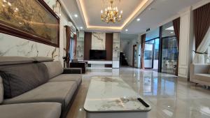 a living room with a couch and a table at Villa Homestay Thanh Hiền in Ho Tram