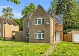 a brick house with a garage in a yard at Elegant 3 Bedroom Detached House By Your Lettings Short Lets & Serviced Accommodation Peterborough With Free WiFi & Parking in Brampton Grange