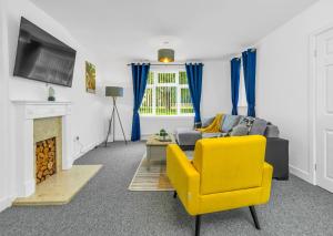 a living room with a couch and a yellow chair at Elegant 3 Bedroom Detached House By Your Lettings Short Lets & Serviced Accommodation Peterborough With Free WiFi & Parking in Brampton Grange