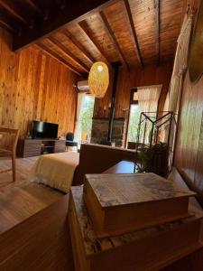 a bedroom with a bed and a couch and a television at Ser Monte Hospedaje in La Población