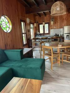 a living room with wooden walls and a table and chairs at Ser Monte Hospedaje in La Población