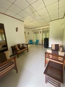 Una gran sala de estar con sofás y sillas. en Gama villa, en Ahangama
