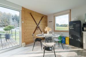 a kitchen and dining room with a table and chairs at Le Petit Chalet - Vue montagne in Le Tholy +9 photos