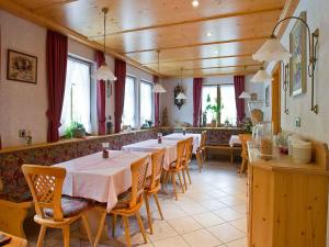 a dining room with a long table and chairs at Gästehaus Herrmann in Bad Rippoldsau-Schapbach