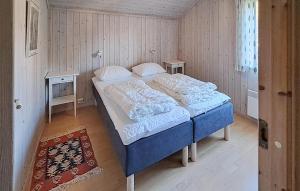 a large bed in a room with two tables at Gaupe - Hytte 5 in Øvre Ramse