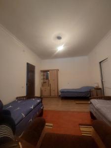 a living room with two beds and a couch at Sam HOTEL in Noyemberyan