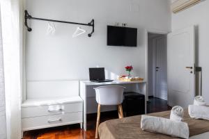 a bedroom with a desk with a computer and a chair at Fantastic Rome Guest House in Rome