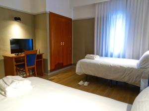 Cama o camas de una habitación en Hotel Ciudad del Sol