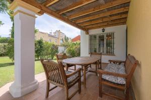 a patio with a table and chairs on a porch at Rocio in El Puerto de Santa María