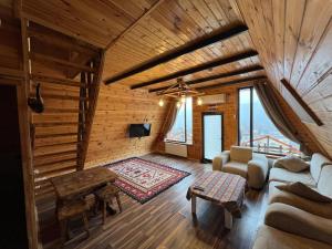 a living room with a couch and a table at ART Otel in Qusar