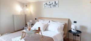 a bedroom with a bed with a night stand next to it at Quick Home Mimosa in Alice Castello