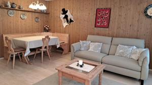 a living room with a couch and a table at Ladina 65 (319 St) in Lenzerheide