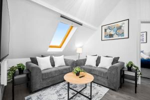 a living room with a couch and a table at Modern Apartment - Accommodates 4 - On Street Parking Available 2CR in Birmingham