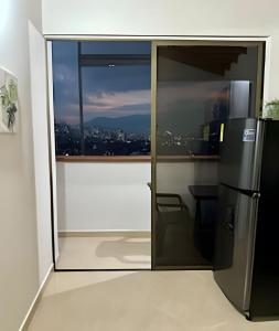 a sliding glass door with a view of a city at beautiful view of the city with local experience in Envigado
