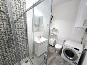 a bathroom with a shower and a washing machine at Apartamento Praia Fuzeta 2 in Fuzeta +49 photos