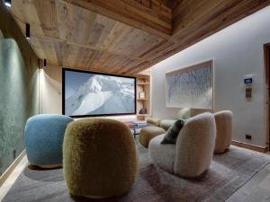 a living room with chairs and a flat screen tv at Chalet 12 pers, Piscine, Hammam, Proche pistes, Val d'Isère - FR-1-567-129 in Val dʼIsère