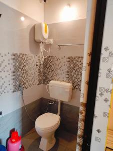 a bathroom with a white toilet and a sink at Nature Beach Stay in Gokarn