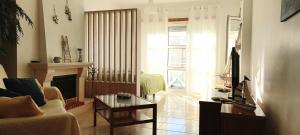 a living room with a couch and a table at Filipe´s House in Baleal