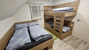a small bedroom with a bed and a bunk room at App DA-LI SPORT KOPE in Slovenj Gradec