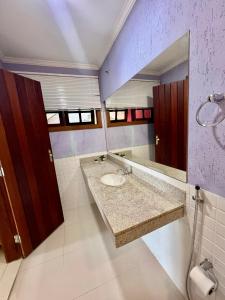 a bathroom with a sink and a mirror at Eco Sapê House in Angra dos Reis +113 photos