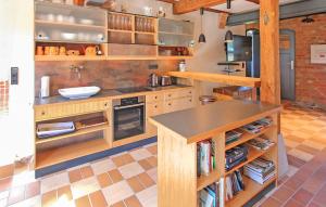 a kitchen with wooden cabinets and a sink and a counter at Ferienhaus Viereck in Viereck +24 photos