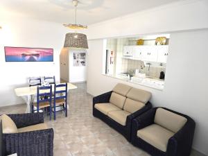 a living room with a dining room and a kitchen at Apartamento Praia Fuzeta 2 in Fuzeta