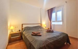 a bedroom with a bed with two towels on it at Cozy Apartment In Torrevieja With Wifi in Torrevieja