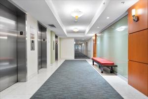 a hallway with a red bench and a carpet at The Tides Ocean Luxury Suites in Hollywood