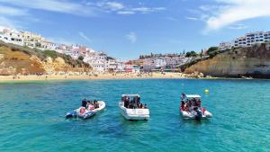 two boats in the water next to a beach at Villa Azzurra by Algarve Vacation in Albufeira