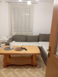 a living room with a table and a couch at Guest house A S S in Sanski most