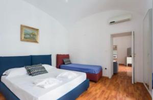a bedroom with two beds and a couch in it at D116 Home - Your Perfect Place in Naples