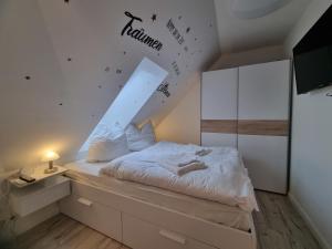 a bedroom with a bed with a sloped ceiling at Haus Peter Wohnung 4 in Sankt Andreasberg +20 photos