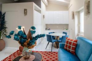 a living room with a blue couch and a table at La CHARTREUSE Luxury Suites 1A-1B-3A-3B in Parma