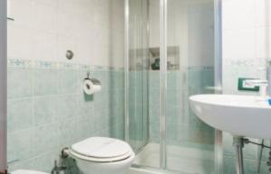 a bathroom with a shower and a toilet and a sink at D116 Home - Your Perfect Place in Naples
